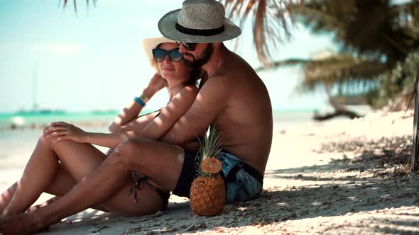 Tropical Vacation Resort.Loving Couple On Tropical Beach.Happy Romantic Couple Relaxing On Bahamas 