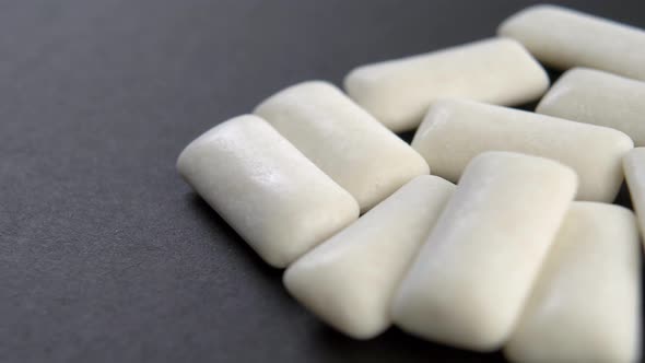 Chewing gum pads on a black background. Macro