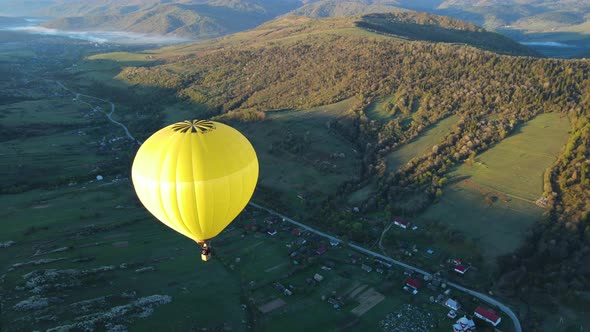 A Balloon Flies Over the Mountains