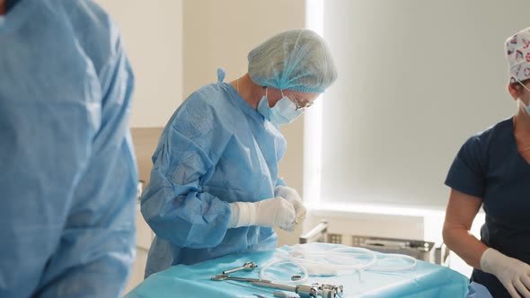 Scrub Nurse Preparing Medical Instruments for Operation