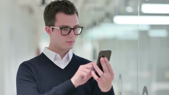 Young Businessman Using Smartphone, Text Messaging