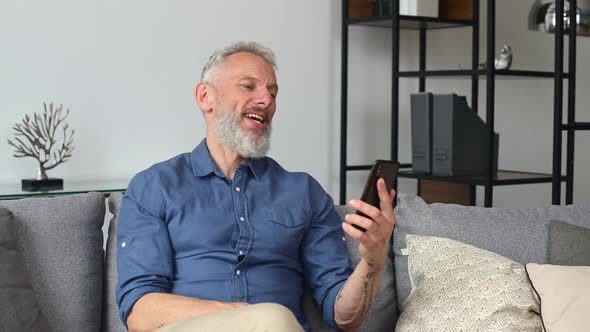 Happy Middle Aged Man Making Video Call on the Smartphone