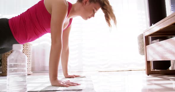 Woman doing exercise in living room