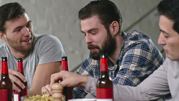 Male Friends Drinking Beer and Chatting