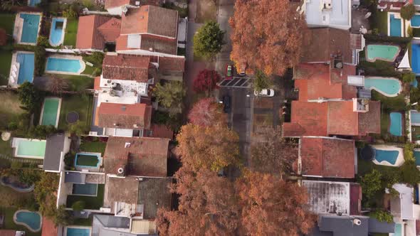 Aerial tracking top-down view over car driving along Parana Avenue in Vicente Lopez residential area