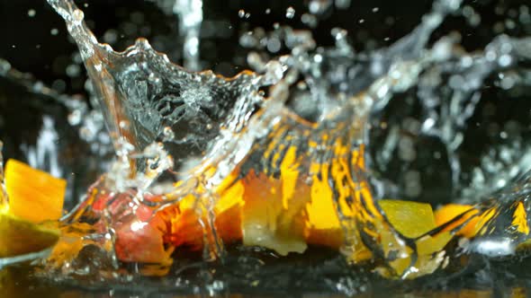 Super Slow Motion Shot of Falling and Splashing Mango Slices Isolated at 1000Fps.