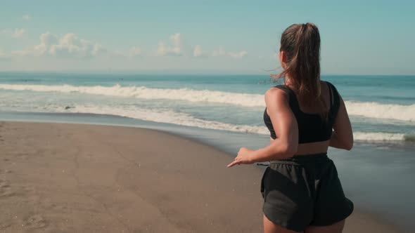 Body Positive Woman is Running on Ocean Beach