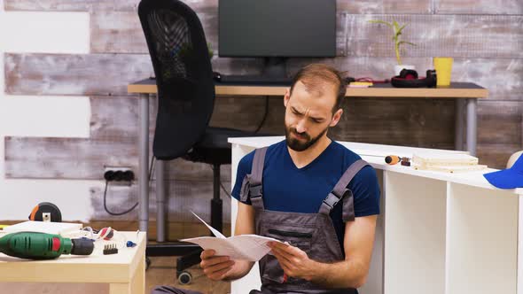 Concentrated Worker Reading Assembly Instruction