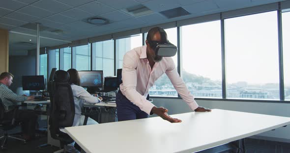 African American businessman wearing VR headset in modern office