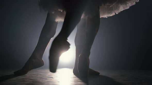 Close Up of Ballet Couple of Dancers As They Practices Exercises on Dark Stage