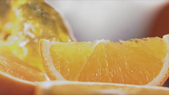 Slow Motion Shot of Orange Juice Splashing Through Orange Slices at 1400Fps