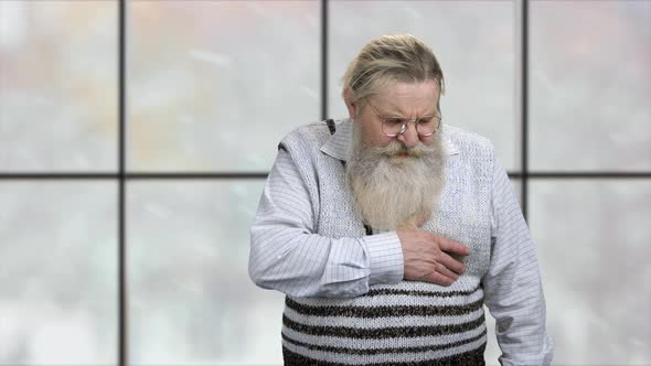 Portrait of Old Caucasian Man Suffering From Chest Pain