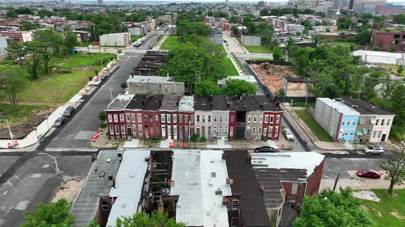 Urban city homes in unsafe neighborhood community. Boarded up houses in disrepair. Poor inner city p