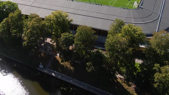 Professionals practicing football at Studenternas arena in Uppsala, aerial fly over shot