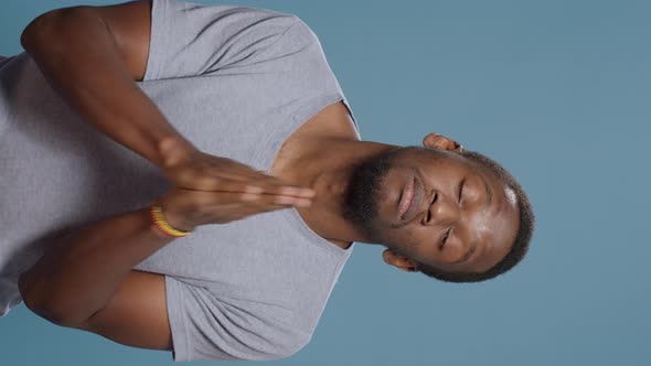Vertical Video Hopeful Man Doign Prayer Gesture with Hands in Front of Camera