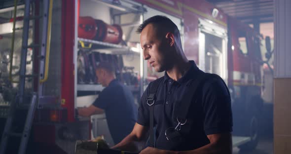 Fireman Cleaning Axe During Work alt
