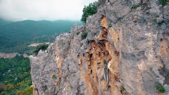 Rocky Cliff Above the Forested Valley and Country Road