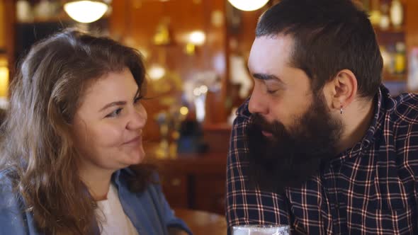 Close Up of Couple Enjoying Evening Drinks and Communicating in Bar