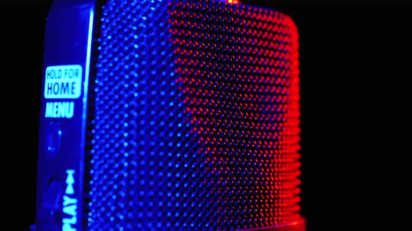 Condenser Microphone Rotates with Blue and Red Backlight. Professional Audio Recorder Close-up