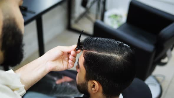 Barber Clips a Part of the Hair Before Cutting