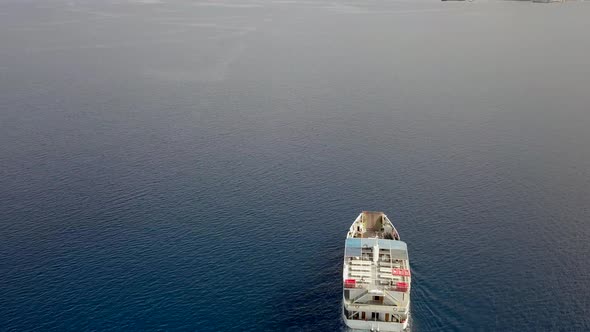 Aerial view behind ferry boat with cars in the mediterranean sea, Kosta, Greece.