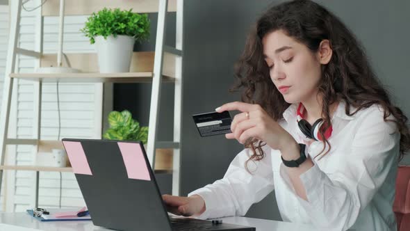 Young Woman Shopping Online with Credit Card Using Computer at Home