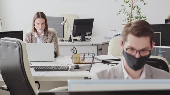 Man and Woman Working in Office during Pandemic