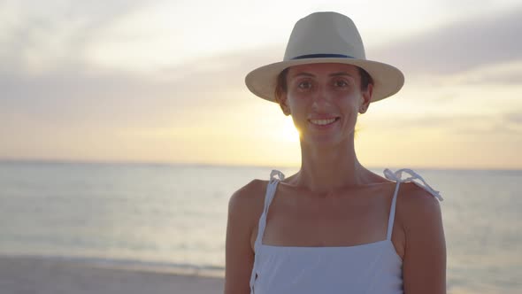 Portrait Young Woman in a Hat on Beach