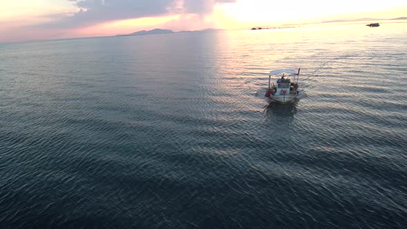 Fishing boat sailing into the sunset.