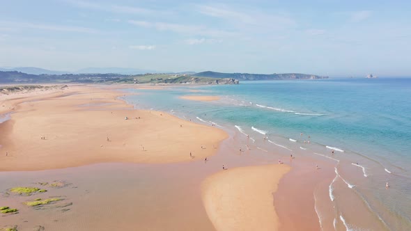 Spectacular beach day where people bathe in sea water. Aerial