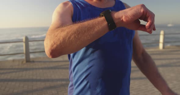 Senior man using smartphone on the promenade