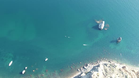 Aerial View From Above on Calm Azure Sea and Volcanic Rocky Shores