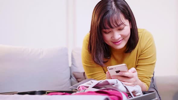 Asian women using smartphones to find travel places.