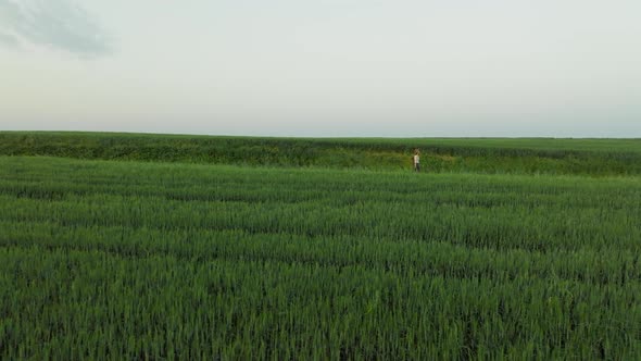 Attractive hiker on the background of a windmill farm, aerial view