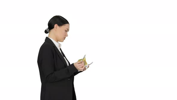Young Woman in a Suit Counting Money on White Background