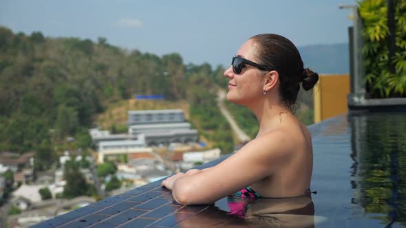 Girl Looks at Picturesque Hilly Landscape with Green Trees