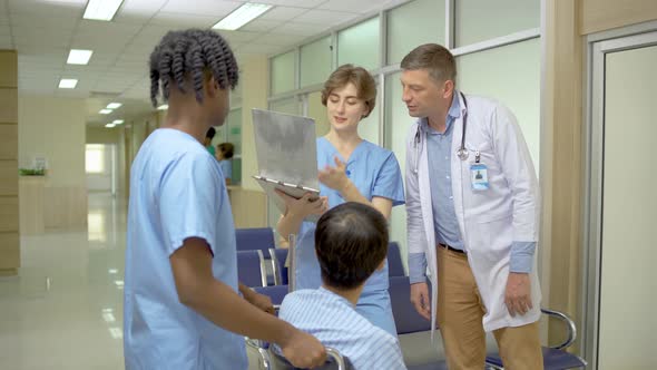 Young two male and female doctor view documents and talk to the patient with care. 