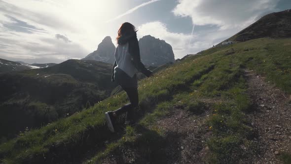 Slow Motion Shot of Happy Young Woman Walks in the Dolomites Mountains Northern Italy in the Summer