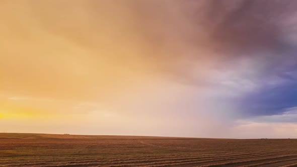 Aerial View Of Sunset Bright Sky Above Summer Hay Field Landscape In Evening