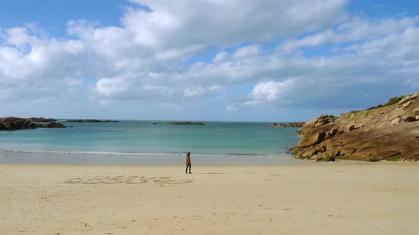 Girl Walking By The Empty Beach