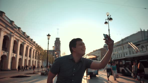 Happy Man Doing Selfies on Phone in the City