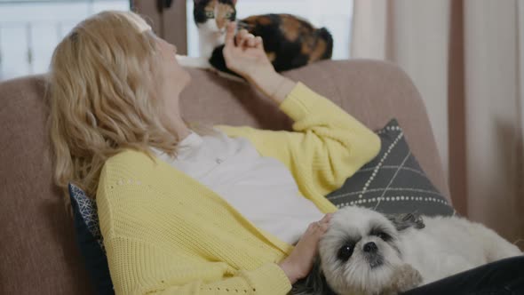 Woman Relaxing with Cute Pets at Home Rbbro