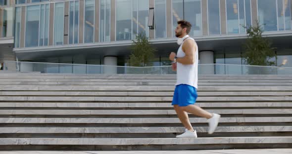 Side View of People Jogging on City Street