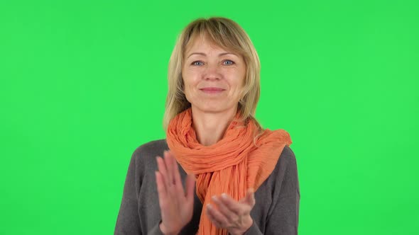 Portrait of Middle Aged Blonde Woman Is Clapping Her Hands