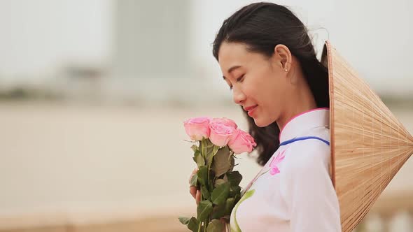 Vietnam Girl in the National Costume and Dress Ao Dai Posing and Smiling for the Camera