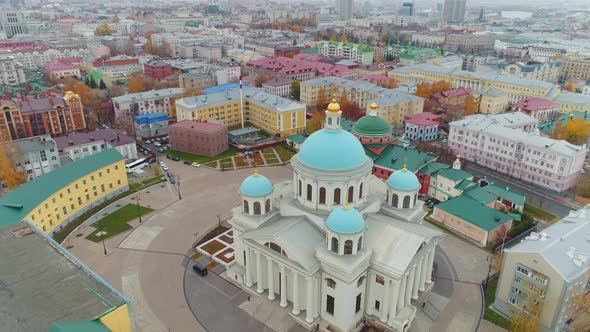Christian Church with Turquoise Domes Among City Buildings