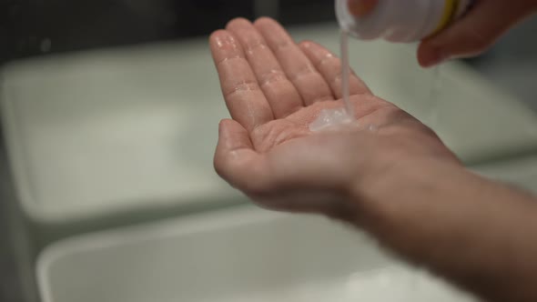 Closeup Male Hand with Shaving Cream Pouring in Slow Motion