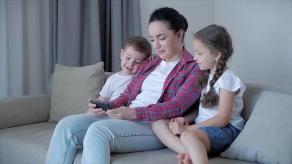 Happy Family,mom and Cute Little Children Watch the Phone,mom Plays with Children at Home,relaxing