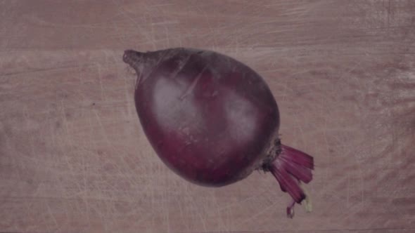 Beetroot Falling on Black Surface and Slices