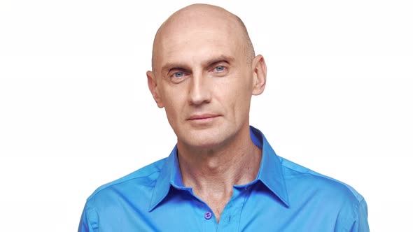 Bold Confident Caucasian Middleaged Male in Blue Shirt Standing on White Background Looking at